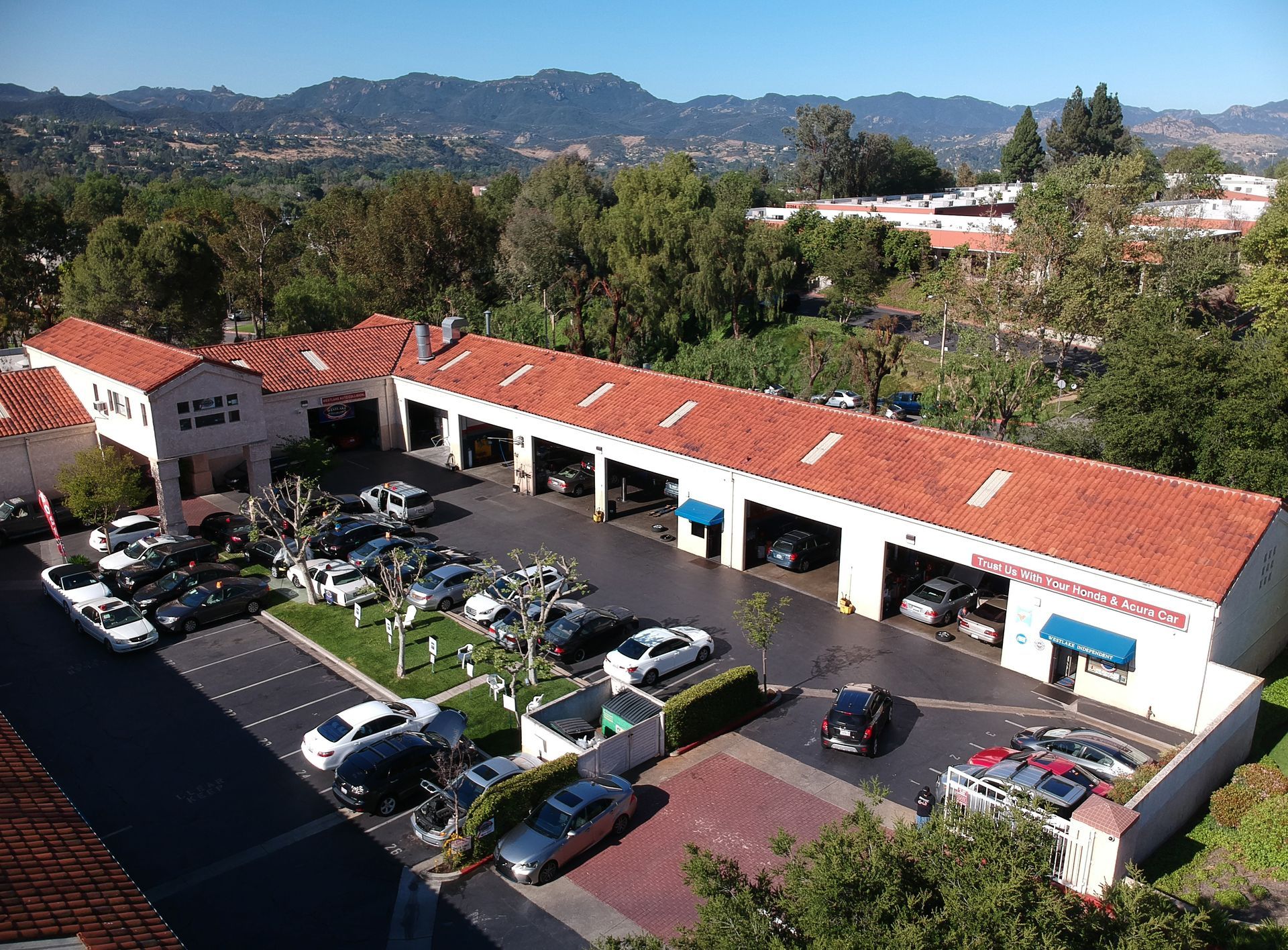 Westlake Independent storefront with red sign, blue awning, and open garage entrance | Westlake Independent Automotive