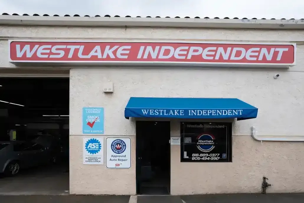 Westlake Independent storefront with red sign, blue awning, and open garage entrance | Westlake Independent Automotive