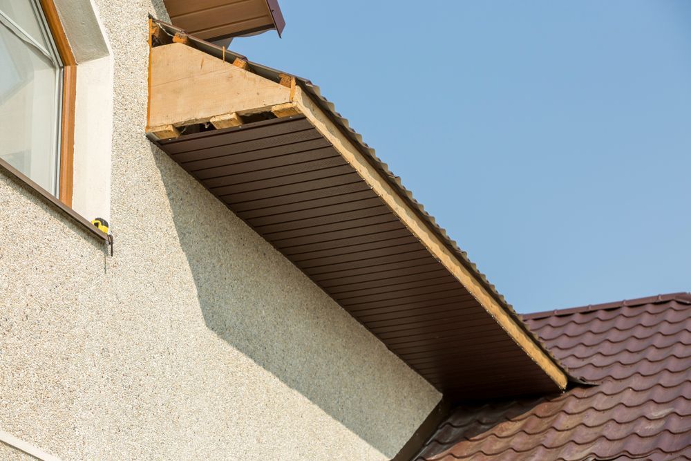 A house with a brown roof and a window on the side.