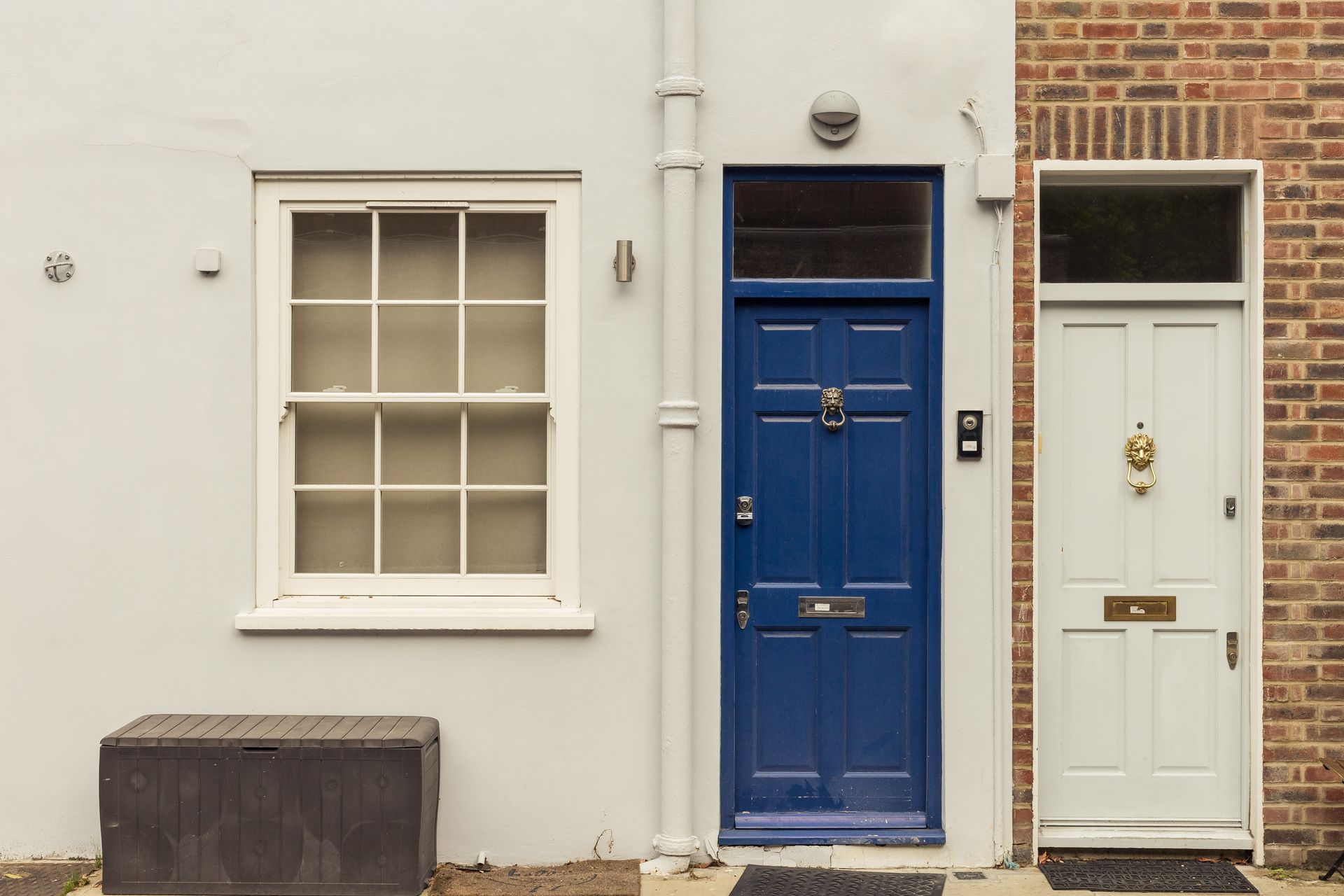 A white house with blue doors and a window