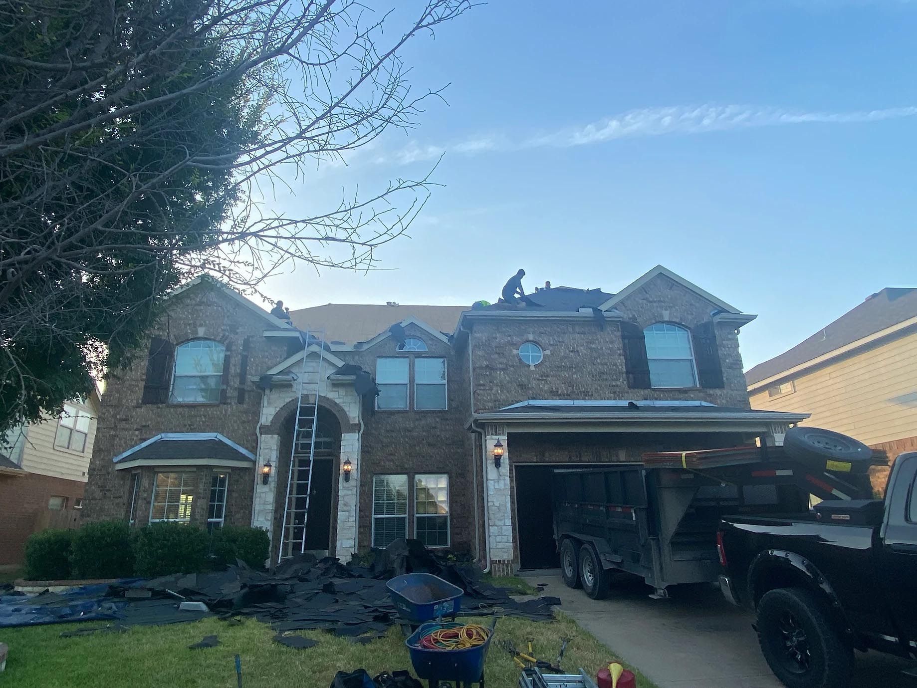 A large brick house with a truck parked in front of it.