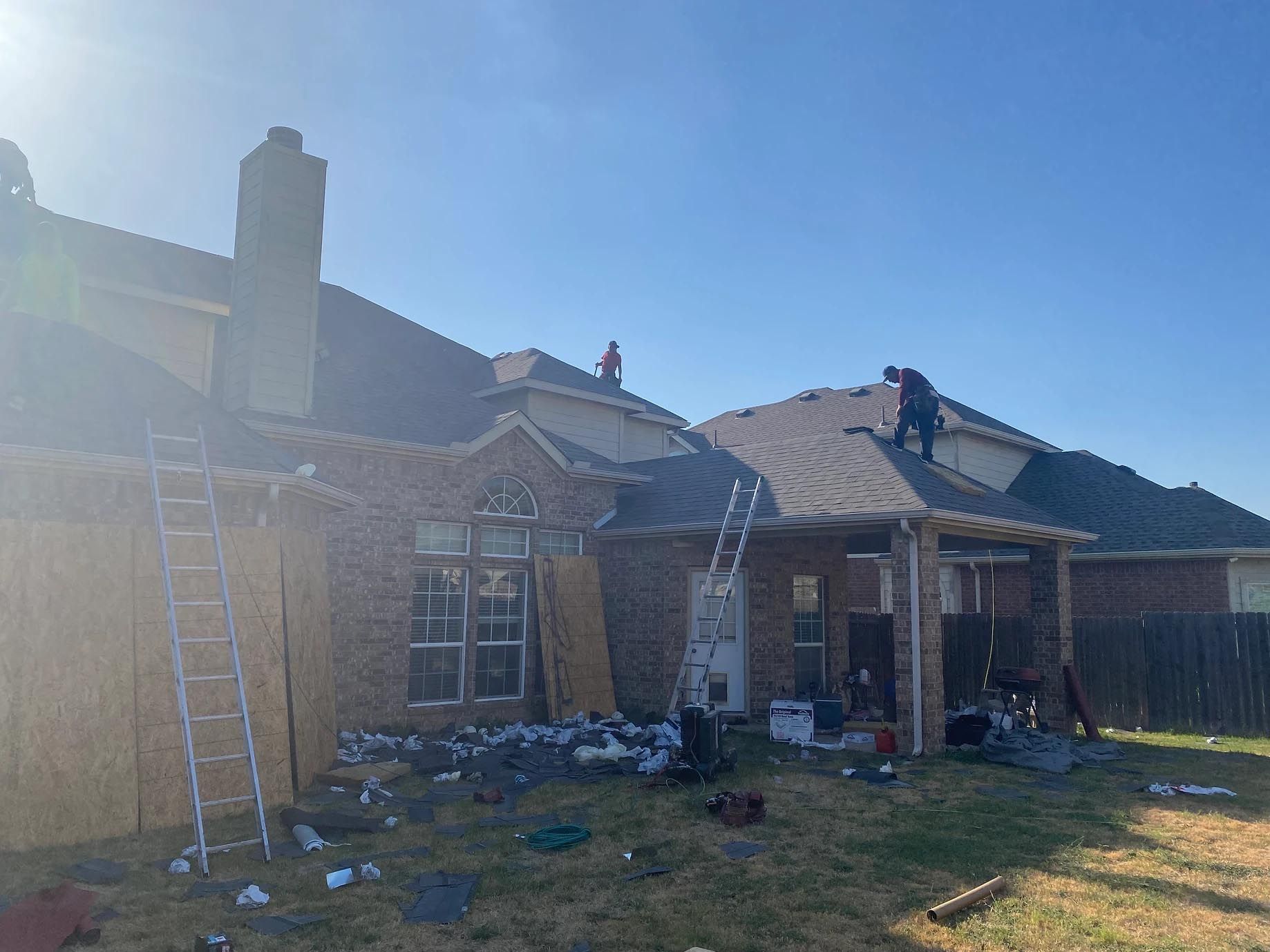 A man is working on the roof of a house.