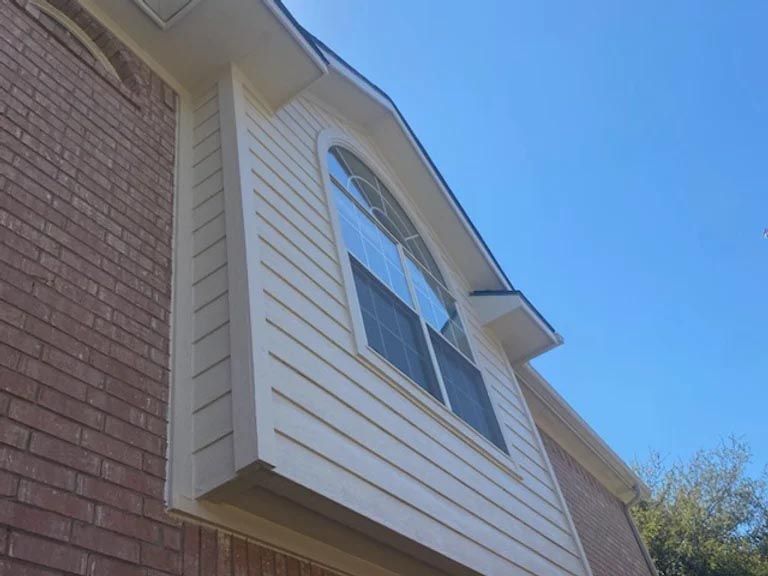 A house with a large window on the side of it