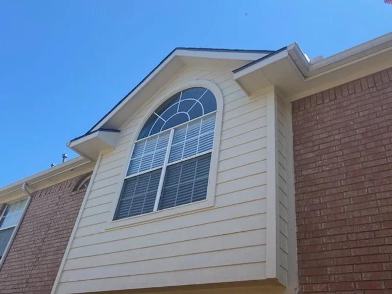 A house with a large window on the side of it
