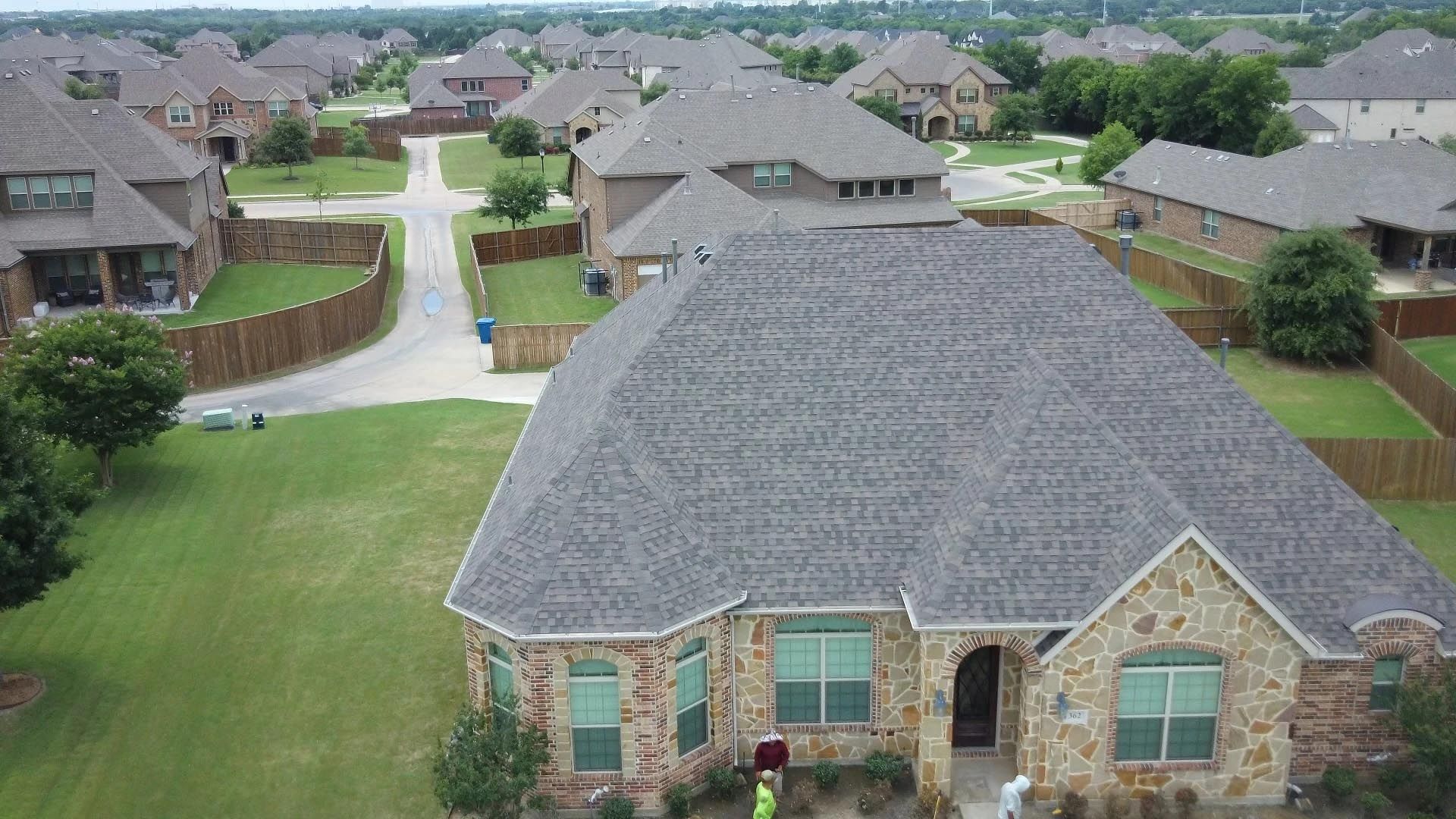 An aerial view of a house in a residential area.