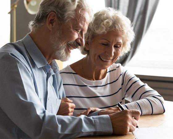 Elderly Couple Writing Will  — Jonesboro, AR — Nickle Law Firm