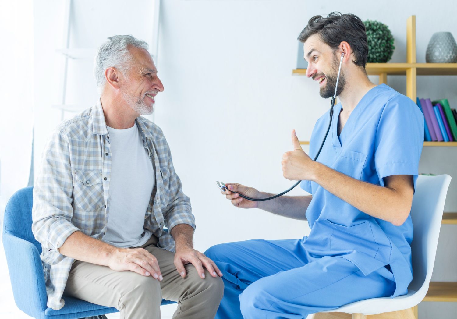 Doctor gives a thumbs-up after examining a smiling older man in a medical setting.