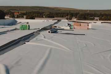 A white roof is being installed on top of a building.