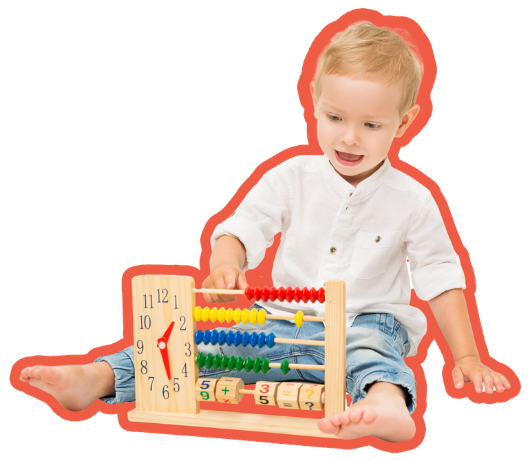 A young child sitting on the floor plays with a wooden abacus and clock toy, smiling, wearing jeans and a white shirt.