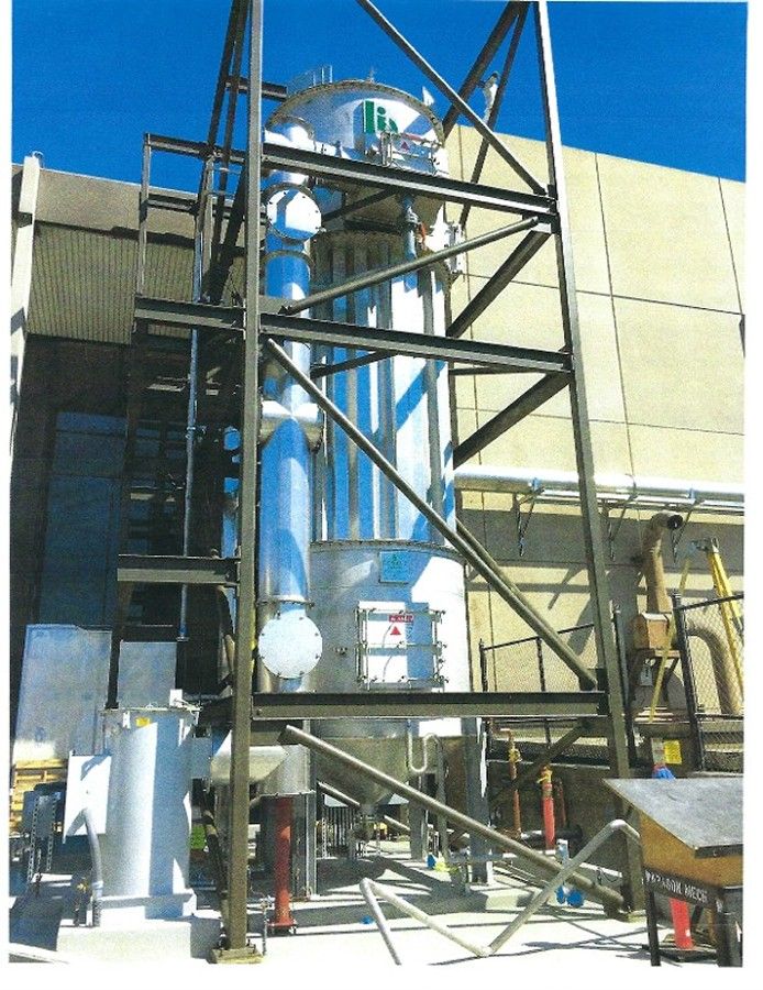 A large metal structure with stairs leading up to it