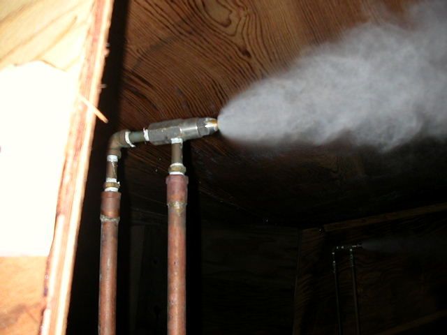 Smoke is coming out of a pipe in a dark room