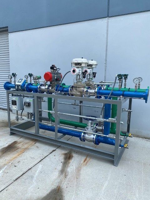 A machine with blue and green pipes and valves