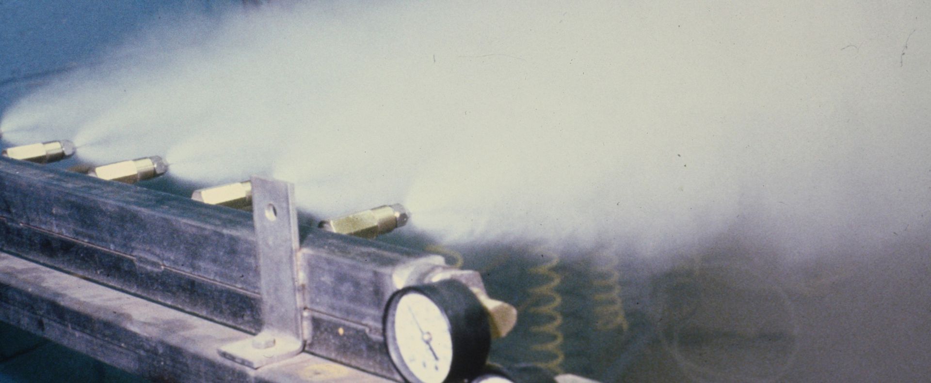 A close up of a pipe with water spraying out of it.