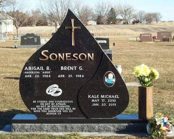 Companion monument in gold star granite with bronze letters, cross, and vase