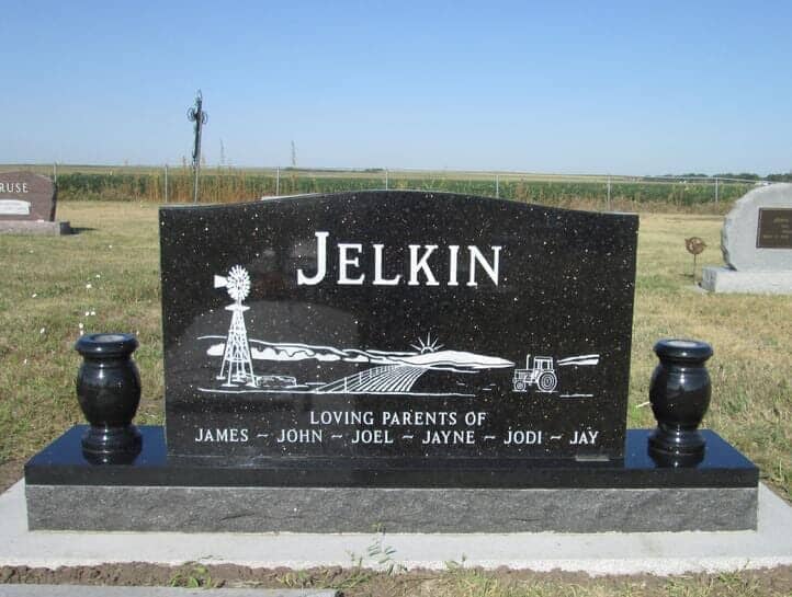 Companion monument with sandblast farm scene on back in black granite