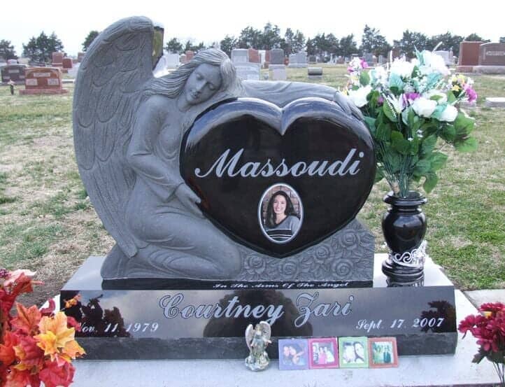 Angel statue monument in black granite with contoured heart, polished bevel front base, and turned vase