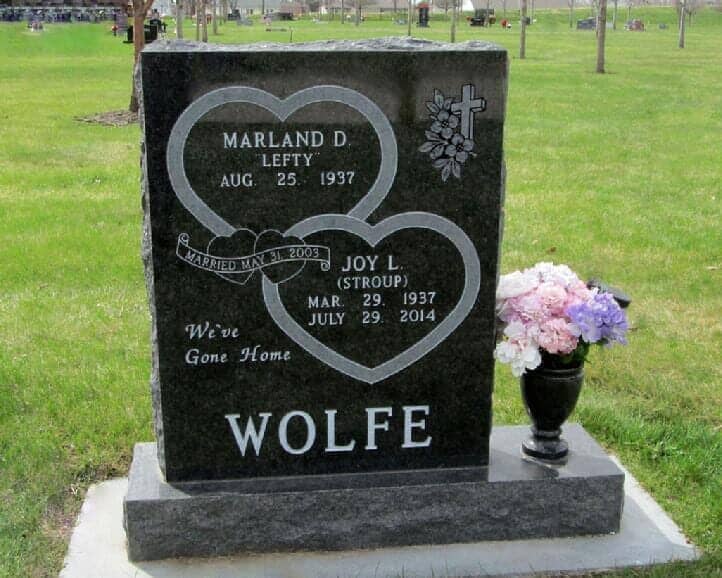 Companion monument with double heart design in black granite with turned vase