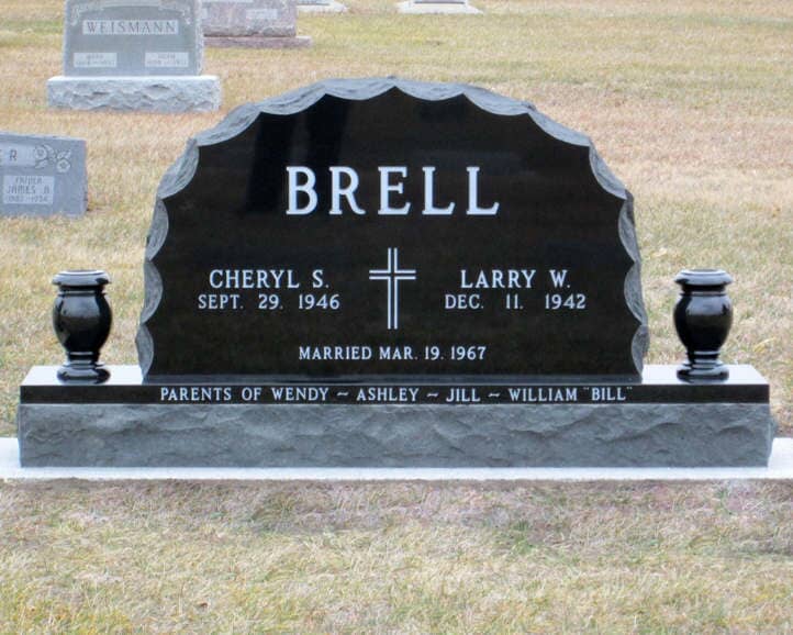 Companion monument in scalloped black granite with turned vases