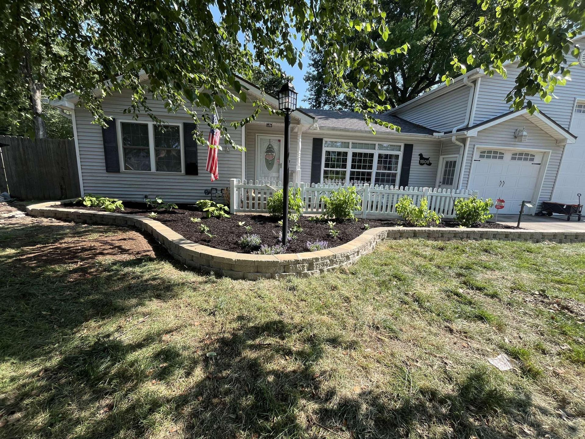 A white house with a large lawn in front of it.