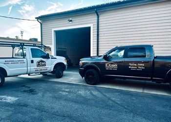 Two trucks are parked in front of a building.