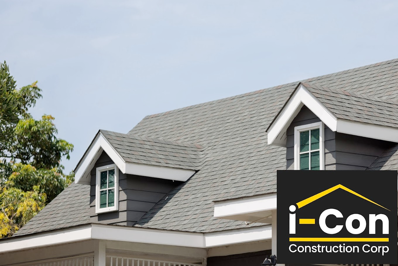 Gray shingled roof with dormers, blue sky, and i-Con Construction Corp. logo.