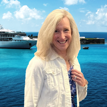 Eileen Murphy sitting at a desk at Land and Sea Travel