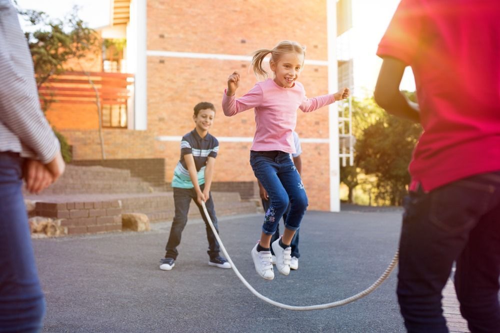 A Group of Children Are Jumping a Jump Rope in a Playground — Kinburra Preschool (Kincumber) in Kincumber, NSW
