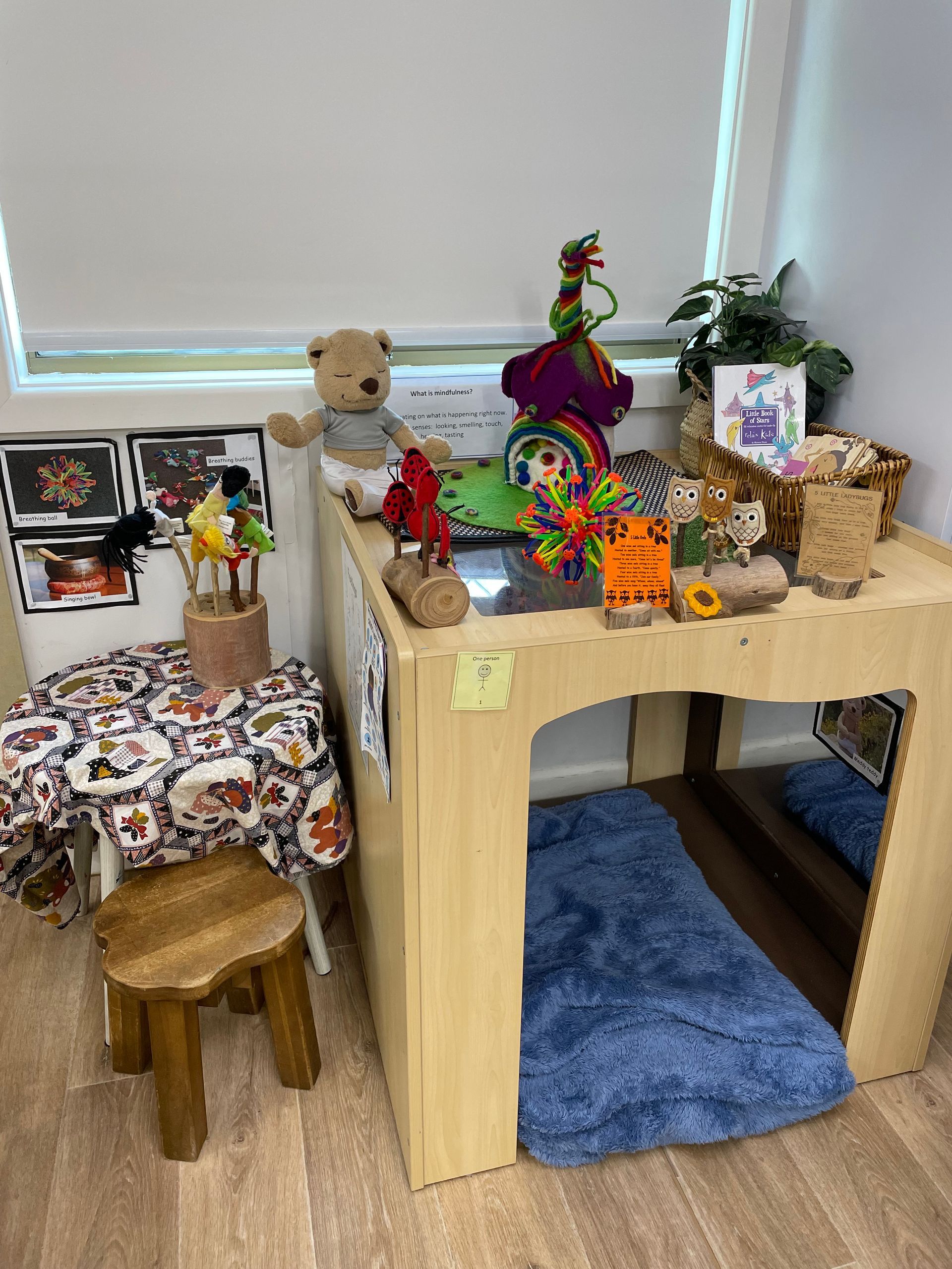 A child's play area with toys on a wooden table and stool — Kinburra Preschool (Kincumber) in Kincumber, NSW