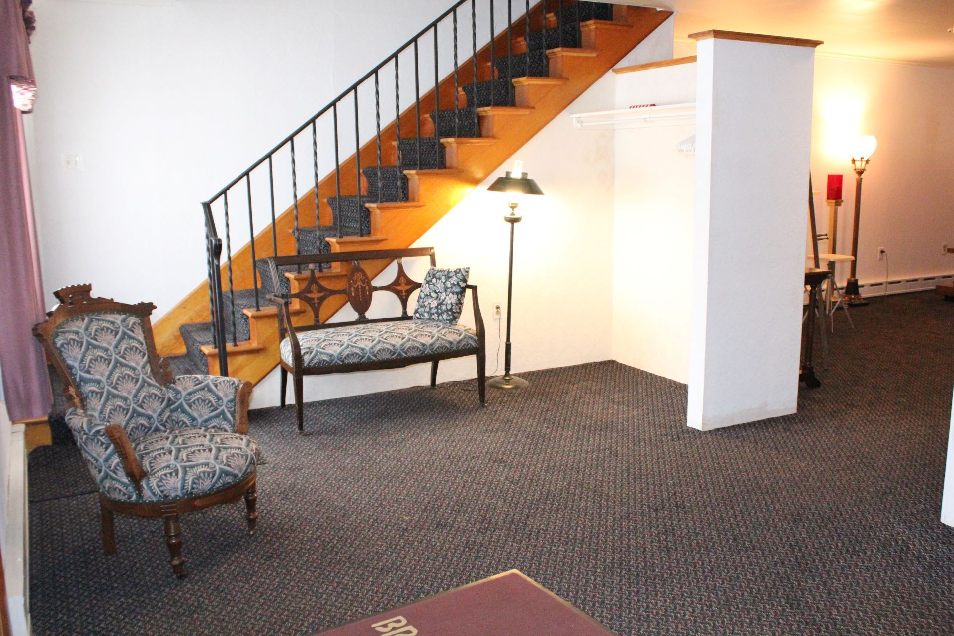 A living room with a staircase leading up to the second floor
