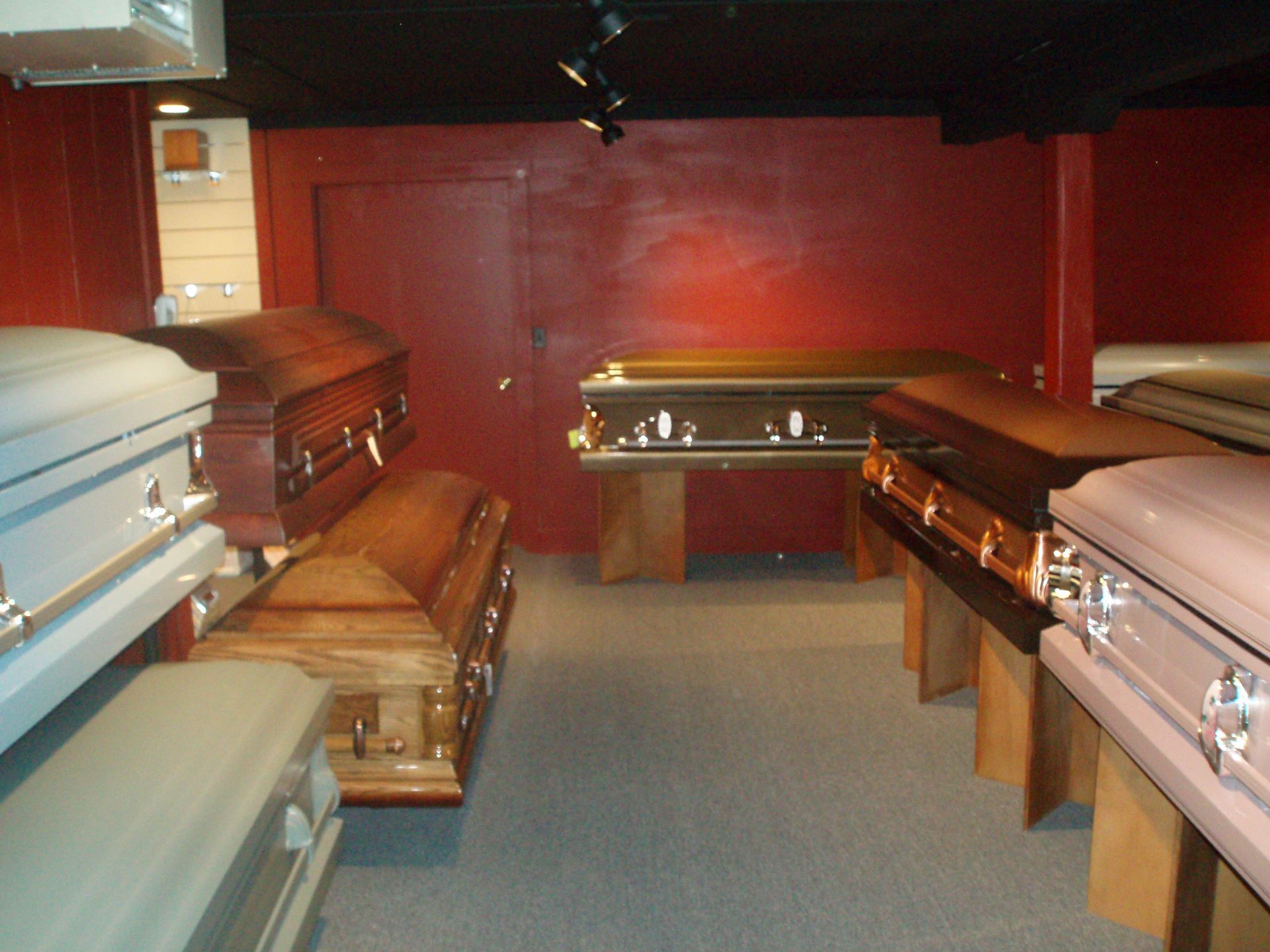 A row of coffins are lined up in a room