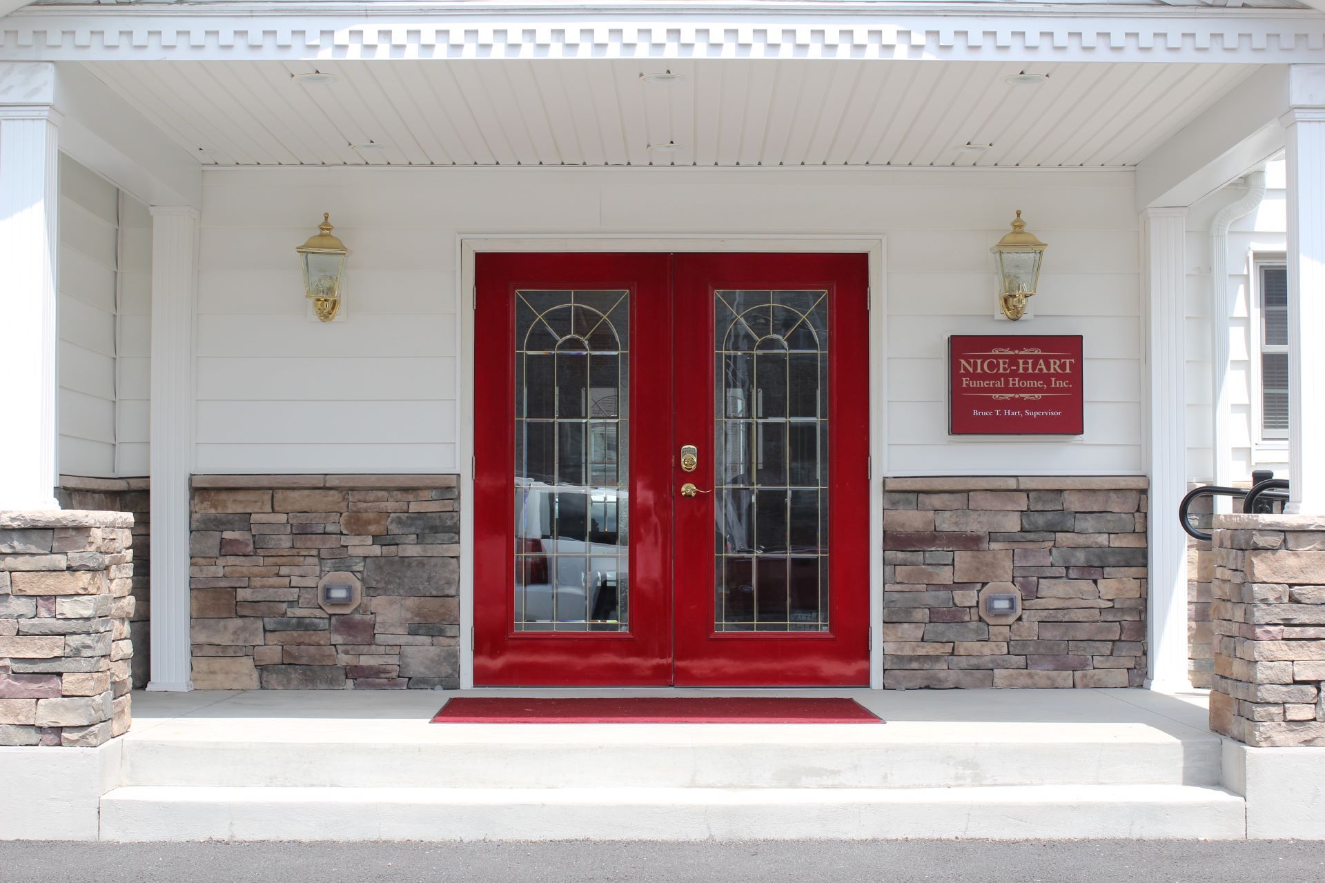 A red door with a sign on it that says 
