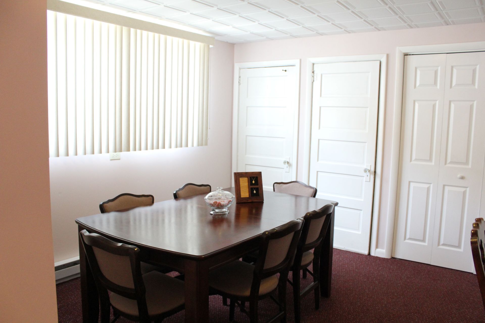 A dining room with a long table and chairs