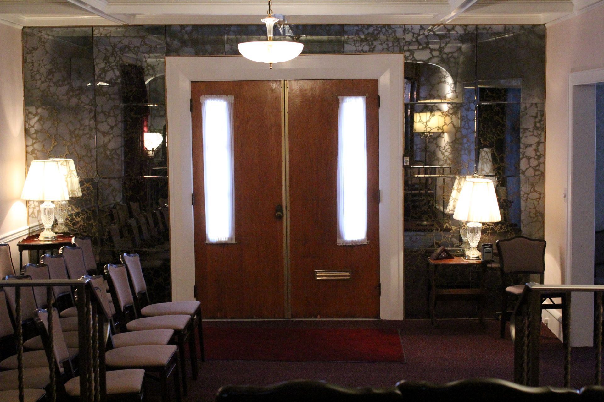 A room with a row of chairs and two doors