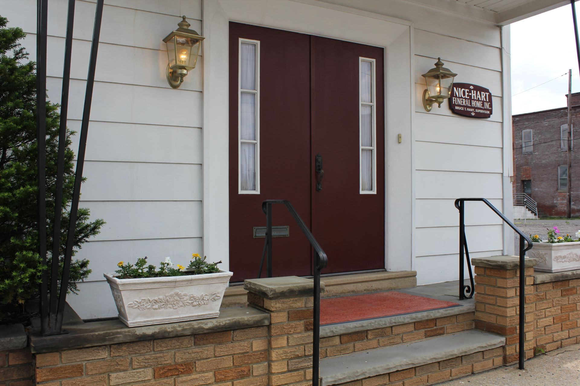 A white house with a red door and steps