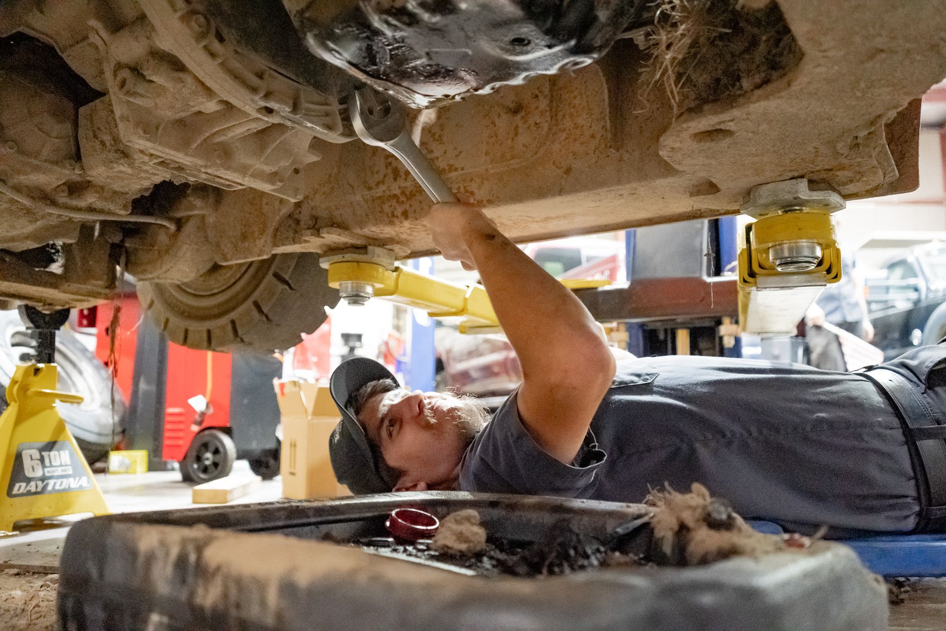 Mechanic Working on the Underside of a Vehicle | FauerWerks Auto & Truck