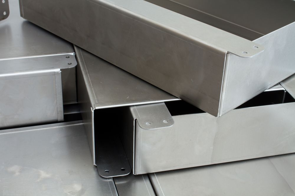 Stack of custom-fabricated, U-shaped stainless steel metal components — Real Engineering in Sydney, NSW