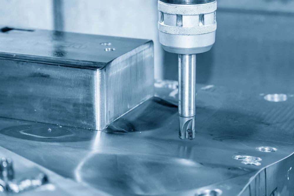 A Machine Is Cutting A Piece Of Metal With A Drill — Real Engineering In Gosford, NSW