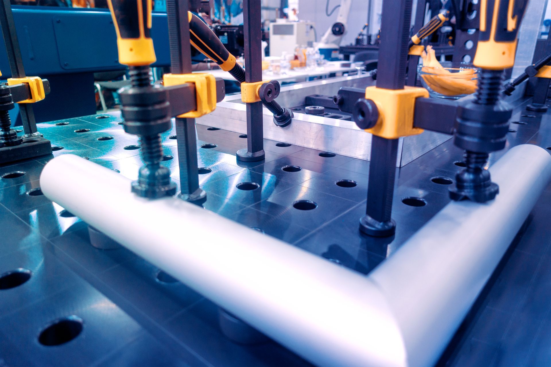 Robotic arms assembling a white sheet on a factory production line — Real Engineering In West Gosford, NSW