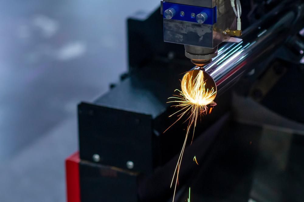 a Machine is Cutting a Metal Pipe in a Factory — Real Engineering In West Gosford, NSW