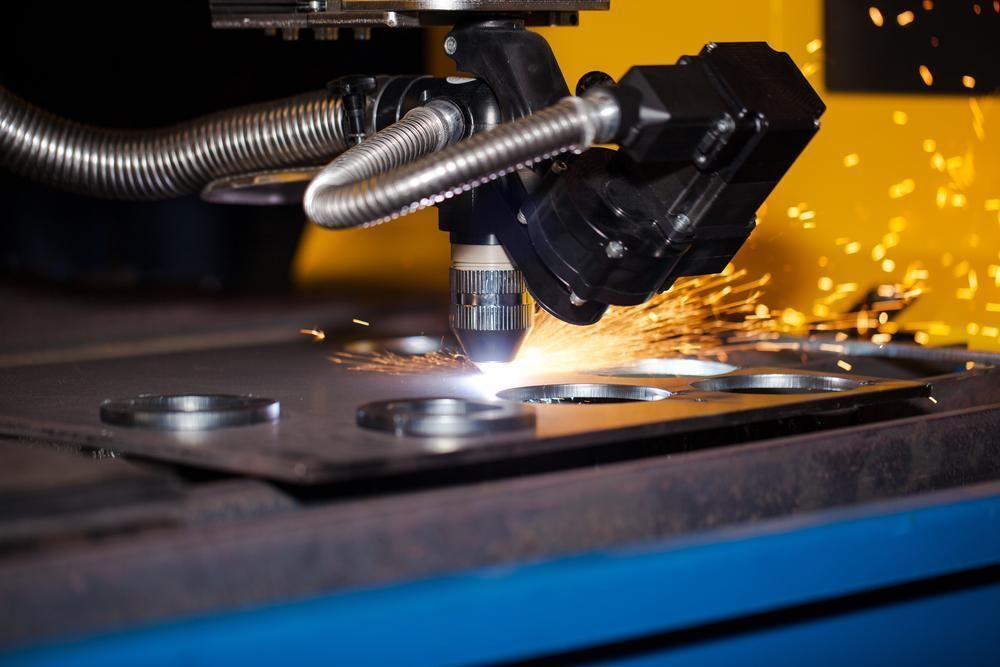 A Machine Is Cutting A Piece Of Metal With Sparks Coming Out Of It — Real Engineering In Newcastle, NSW