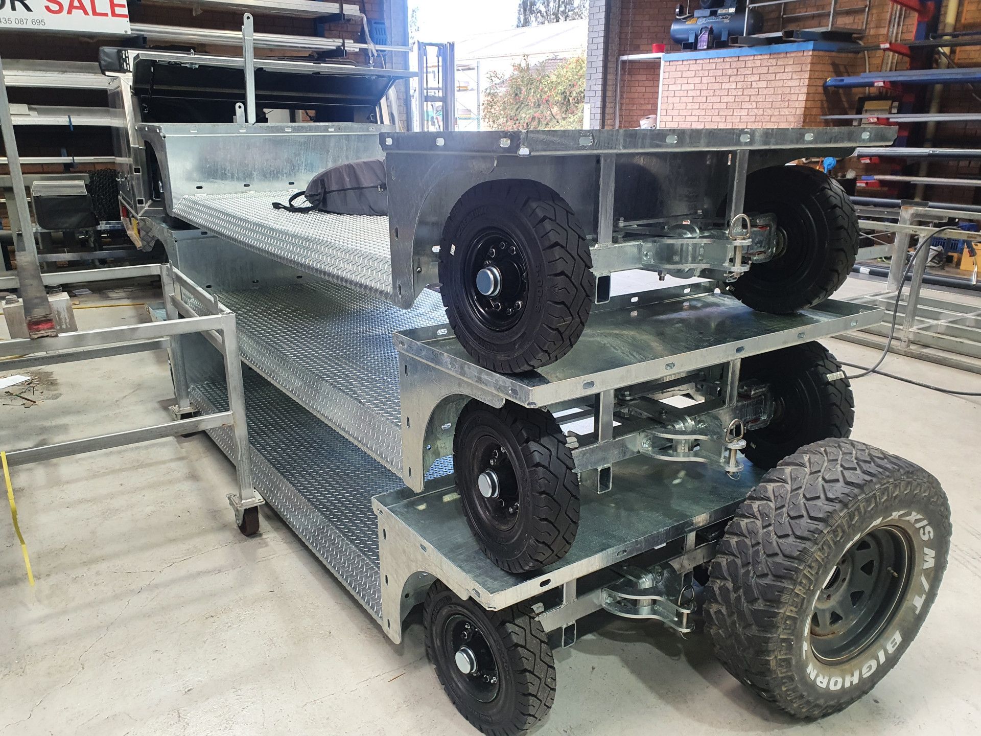 a Truck With a Tray on the Back of It is Parked Next to a Tree — Real Engineering In West Gosford, NSW