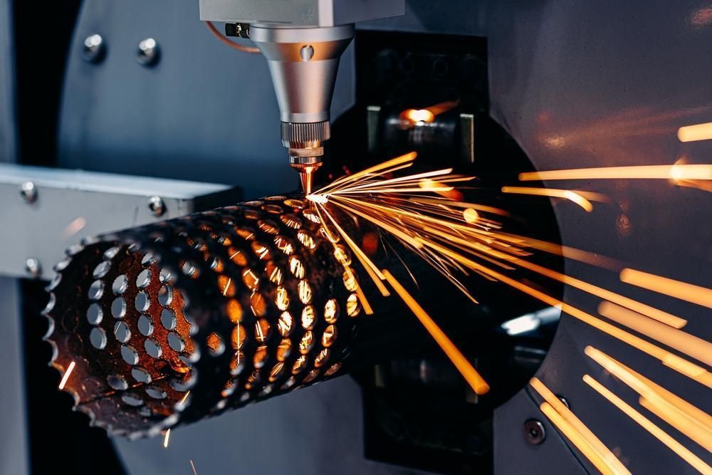 A Machine Is Cutting A Metal Pipe With Sparks Coming Out Of It — Real Engineering In Somersby, NSW