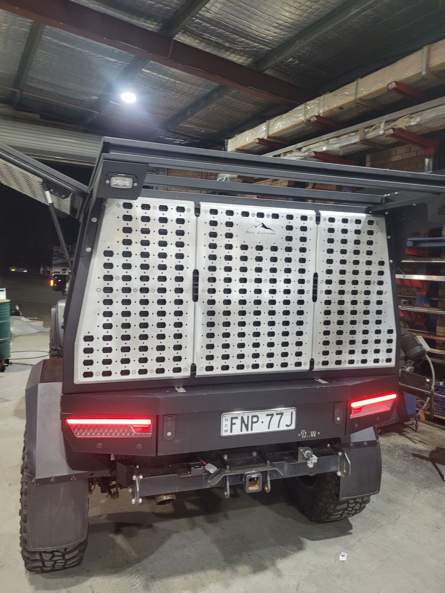 Rear View of a Dark Off-road Truck Featuring a Large Metal — Real Engine Hunter Valley, NSW