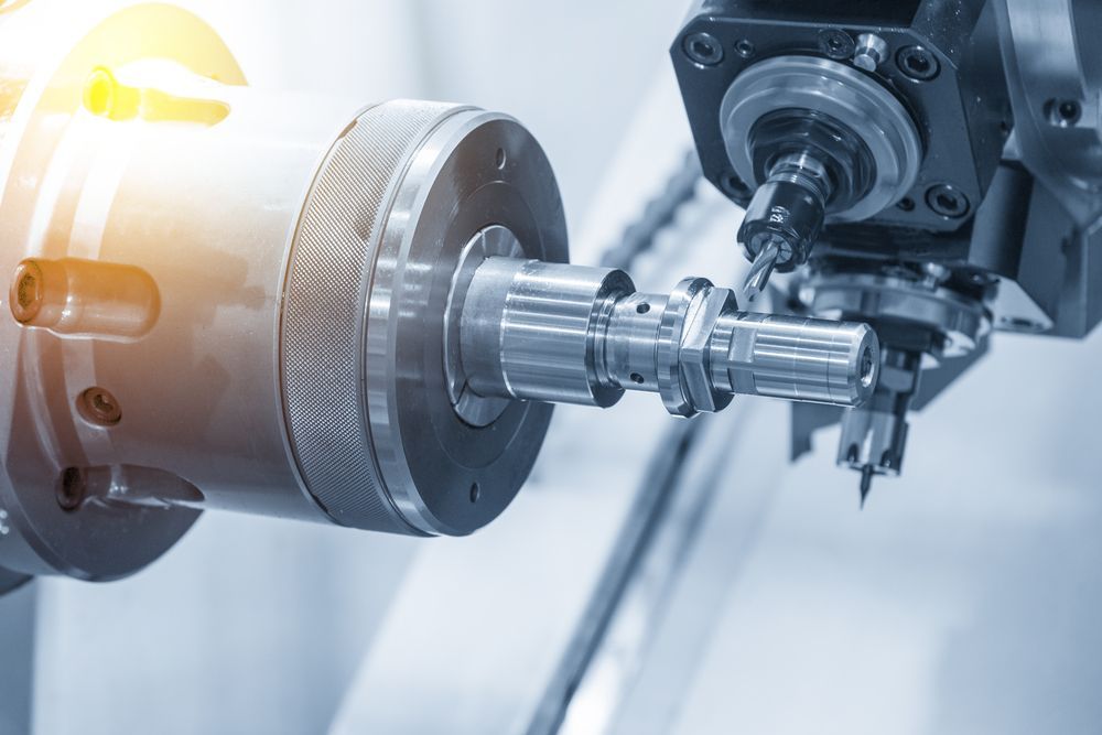 A Close Up of a CNC Machine or Turning Machine drilling the metal rod — Real Engineering In West Gosford, NSW