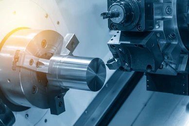 a Machine is Cutting a Metal Pipe With Sparks Coming Out of It — Real Engineering In West Gosford, NSW
