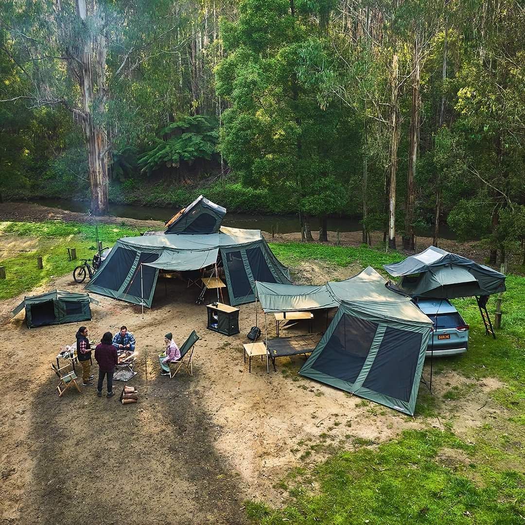 A Woman Is Standing Next To A RV With Bikes Parked In Front Of It — Real Engineering In West Gosford, NSW