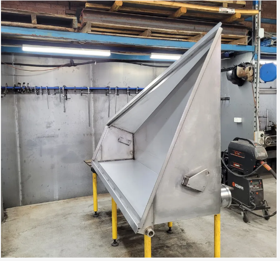 a Man is Grinding a Piece of Metal With a Grinder in a Factory — Real Engineering In West Gosford, NSW