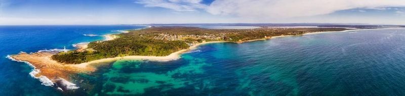 An aerial view of a small island in the middle of the ocean.