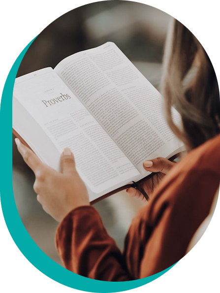 Person holding open book; reading the book of Proverbs.