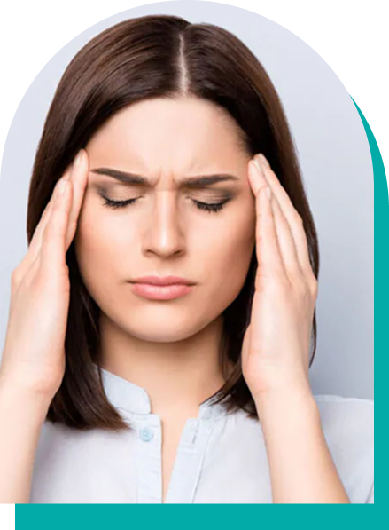 Woman with closed eyes, hands on temples, showing signs of a headache.
